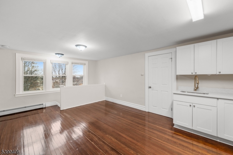 76 Van Ness Terrace, Unit 2 Maplewood, NJ 07040 - Photo 5 of 9 a view of a kitchen with wooden floor and cabinets