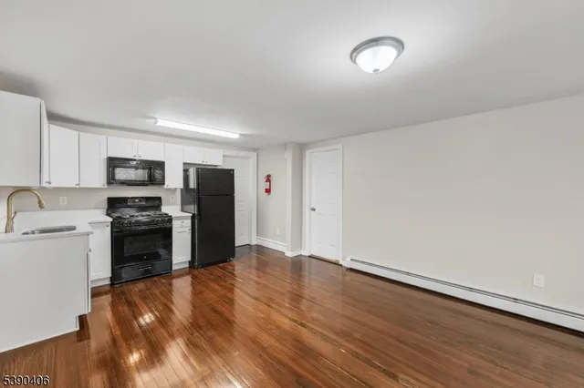 a kitchen with a refrigerator and a stove top oven