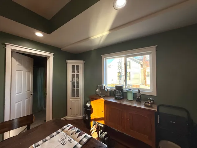 a view of a workspace with furniture and a window