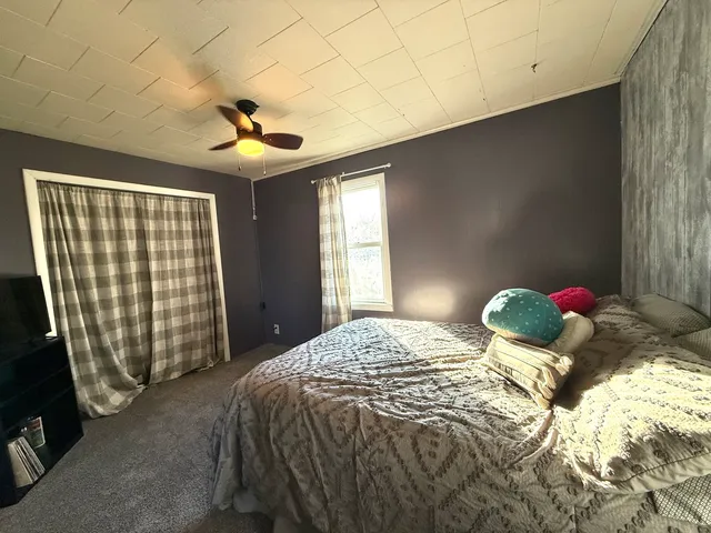 a bedroom with a bed and a chandelier