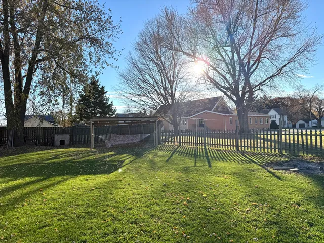 a view of backyard with wooden fence