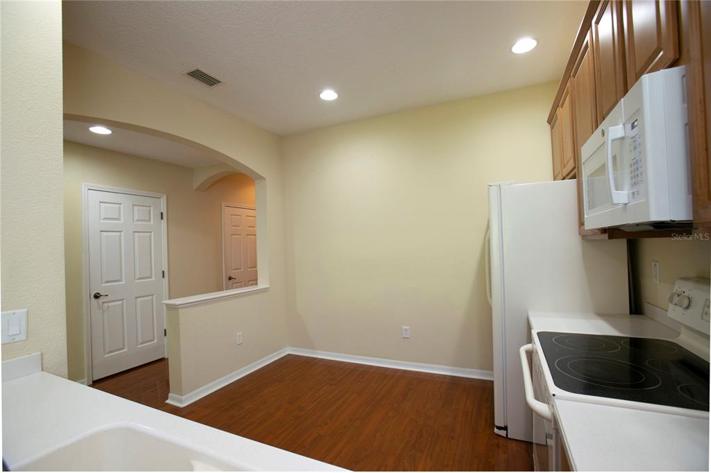 11919 Essington Street New Port Richey, FL 34654 - Photo 2 of 46 a kitchen with a sink and a refrigerator