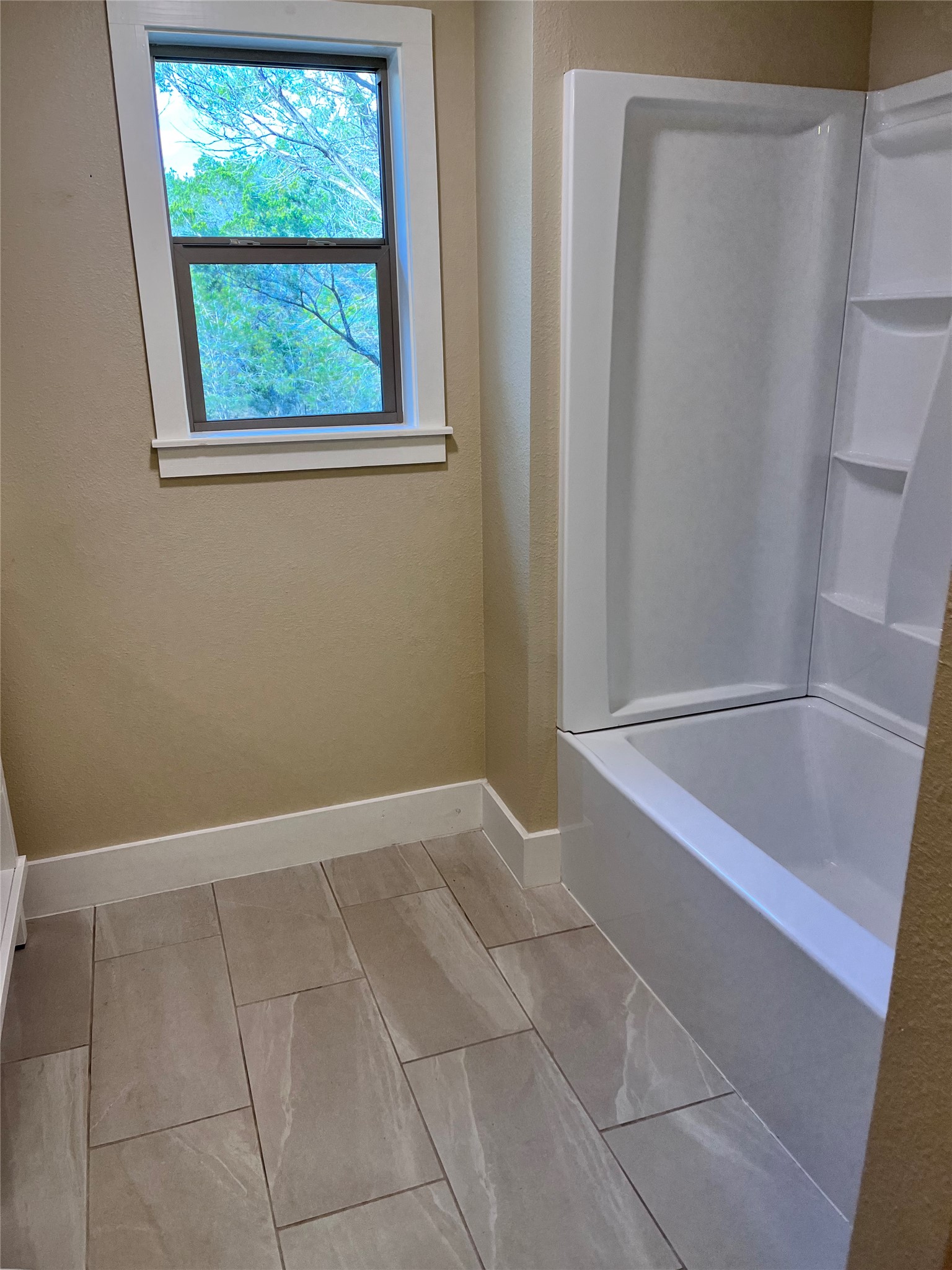 1565 Pump Station Road, Unit B Wimberley, TX 78676 - Photo 10 of 12 Bathroom featuring baseboards and bathtub / shower combination