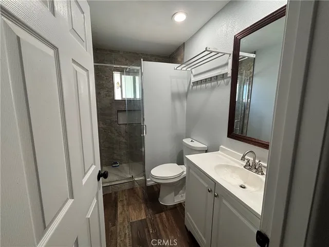 a bathroom with a double vanity sink toilet and shower