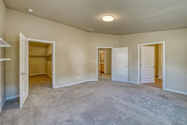 an empty room with windows and closet