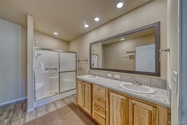 a bathroom with a granite countertop sink and shower