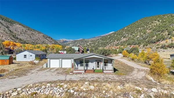 a view of a big house with a mountain in the background