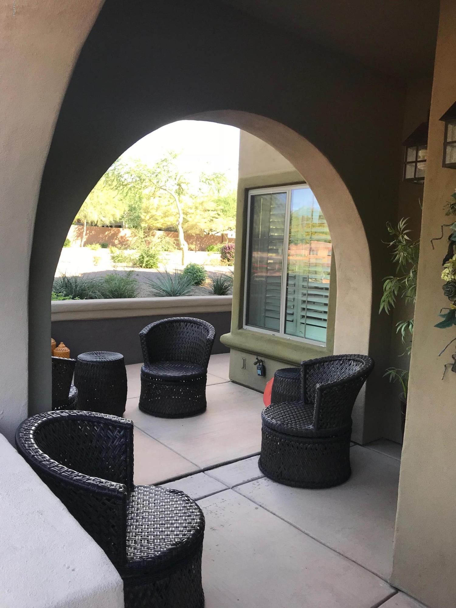 3935 East Rough Rider Road, Unit 1385 Phoenix, AZ 85050 - Photo 1 of 14 a living room with furniture and a large window