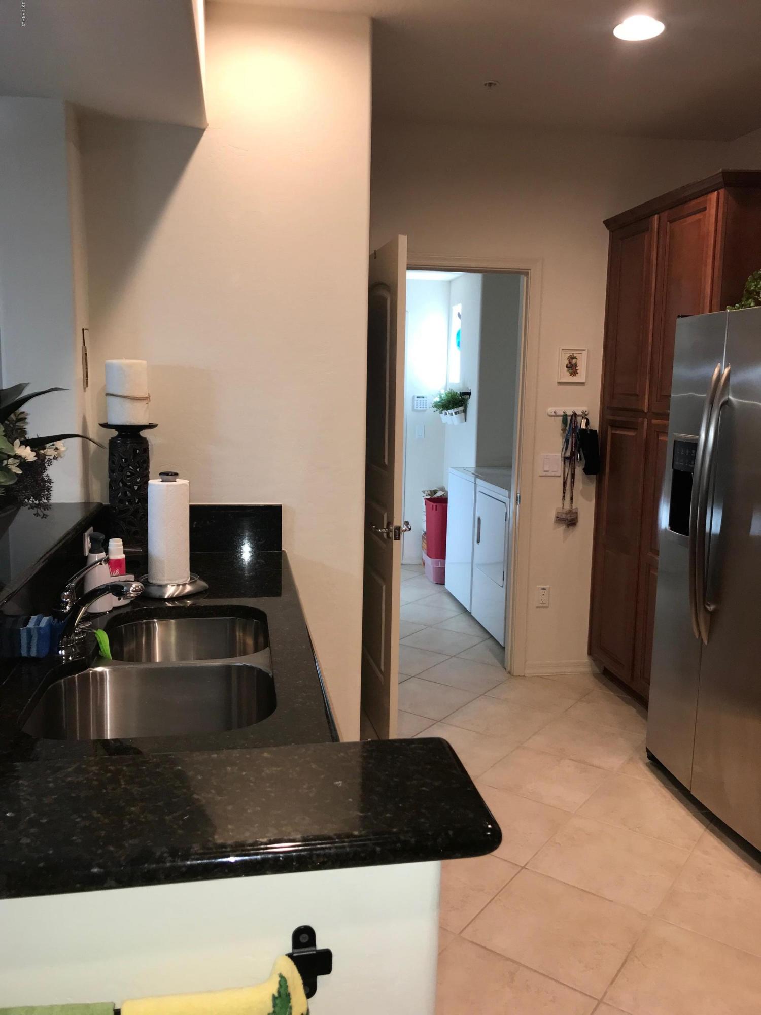3935 East Rough Rider Road, Unit 1385 Phoenix, AZ 85050 - Photo 4 of 14 a kitchen with refrigerator and sink