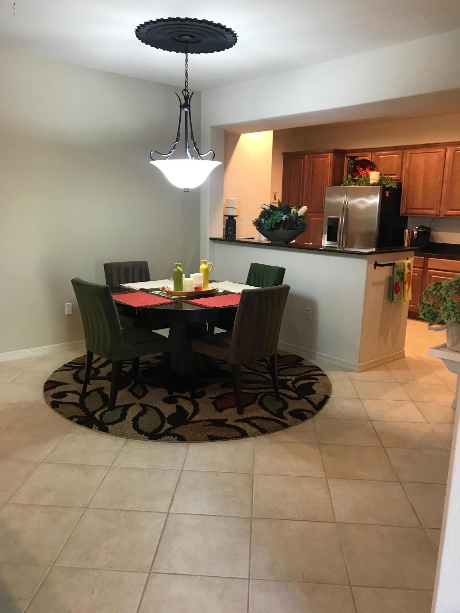 3935 East Rough Rider Road, Unit 1385 Phoenix, AZ 85050 - Photo 5 of 14 a table and chairs in a room