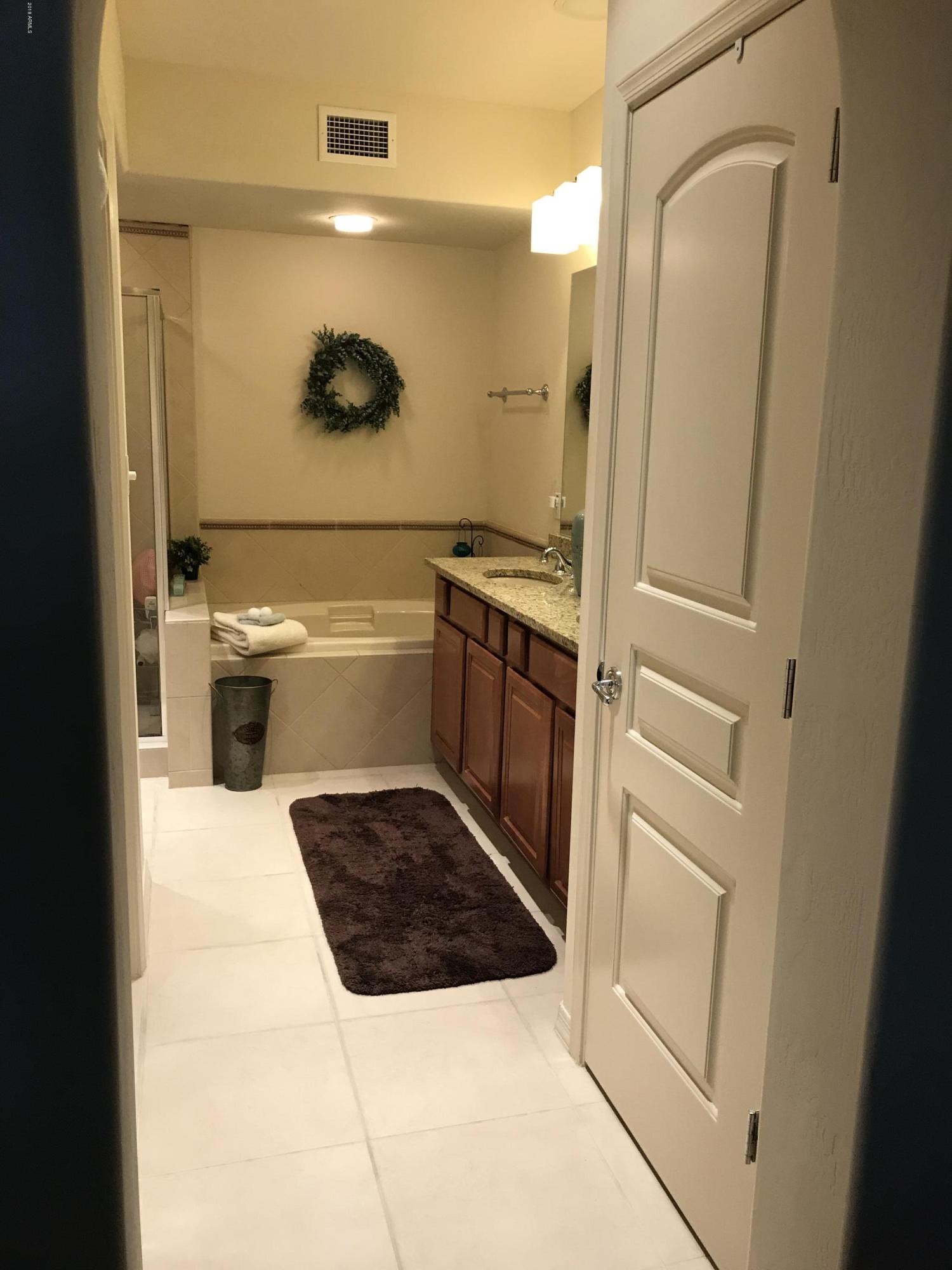 3935 East Rough Rider Road, Unit 1385 Phoenix, AZ 85050 - Photo 7 of 14 a bathroom with a sink a toilet and shower