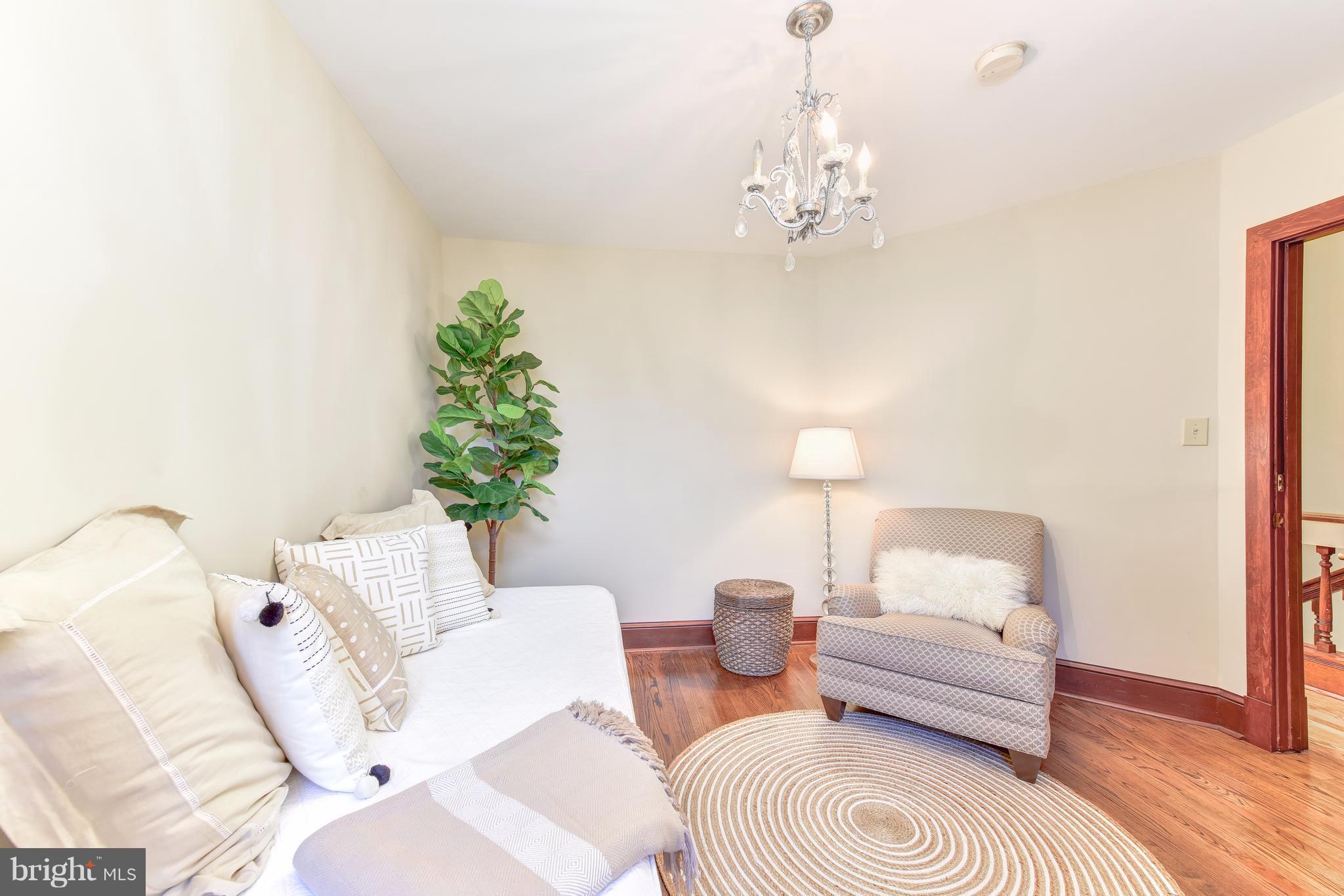 1016 Massachusetts Avenue Northeast Washington, DC 20002 - Photo 11 of 28 a living room with furniture and a chandelier