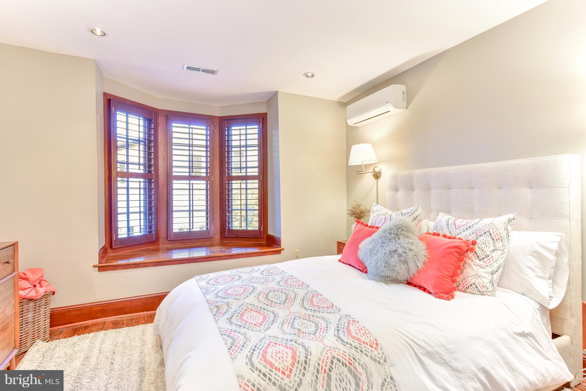 1016 Massachusetts Avenue Northeast Washington, DC 20002 - Photo 12 of 28 a bedroom with a bed and a large window