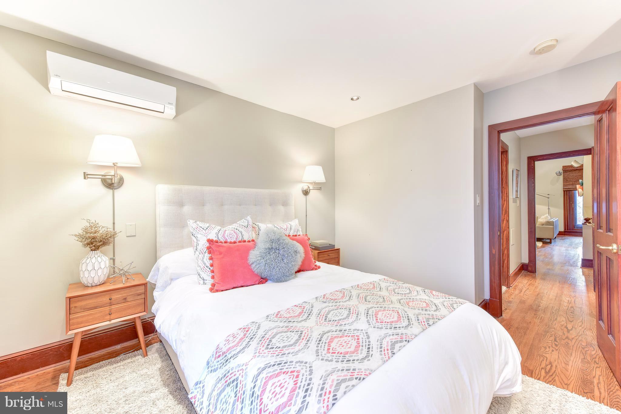 1016 Massachusetts Avenue Northeast Washington, DC 20002 - Photo 13 of 28 a bedroom with a bed and wooden floor