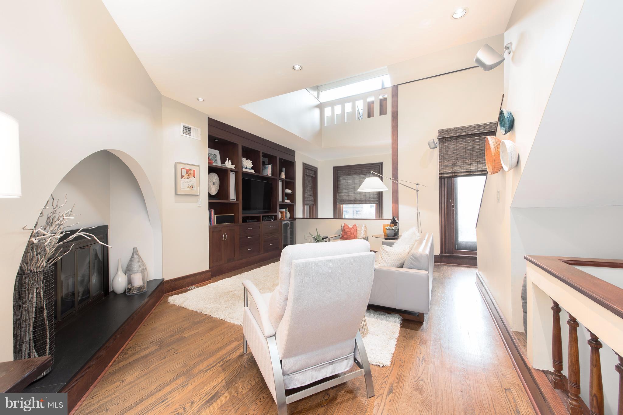 1016 Massachusetts Avenue Northeast Washington, DC 20002 - Photo 15 of 28 a living room with furniture and a wooden floor