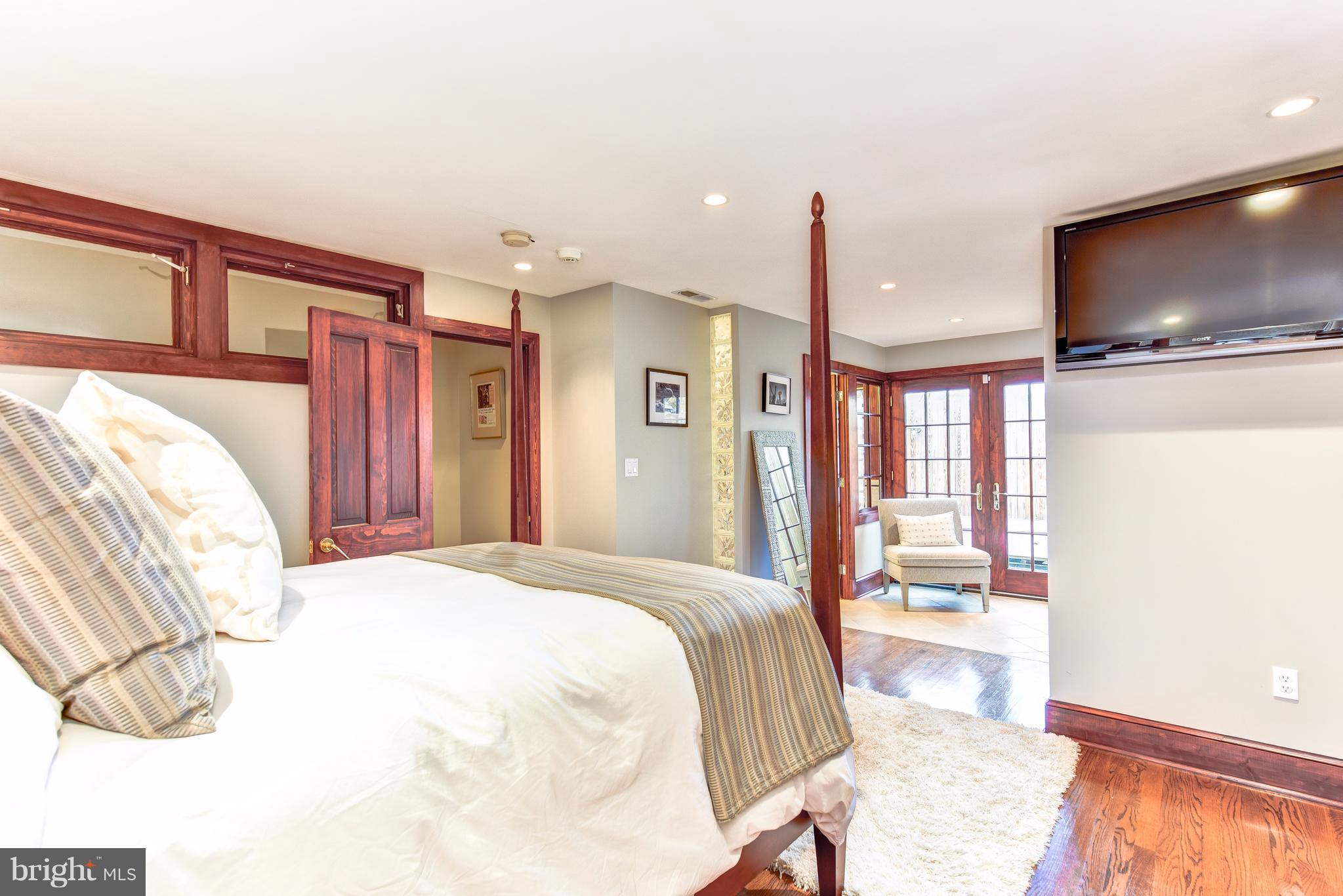 1016 Massachusetts Avenue Northeast Washington, DC 20002 - Photo 17 of 28 a spacious bedroom with a bed and a flat screen tv