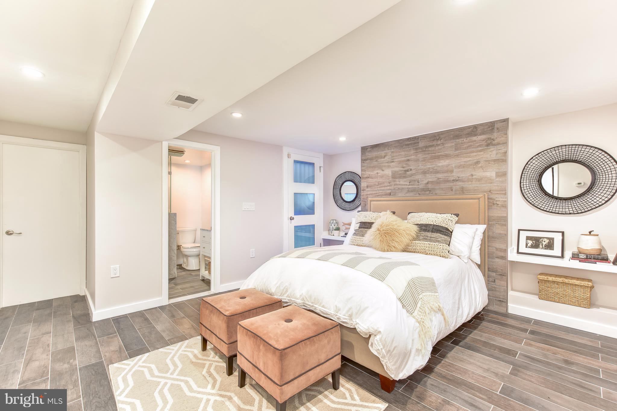 1016 Massachusetts Avenue Northeast Washington, DC 20002 - Photo 24 of 28 a bedroom with a bed and wooden floor