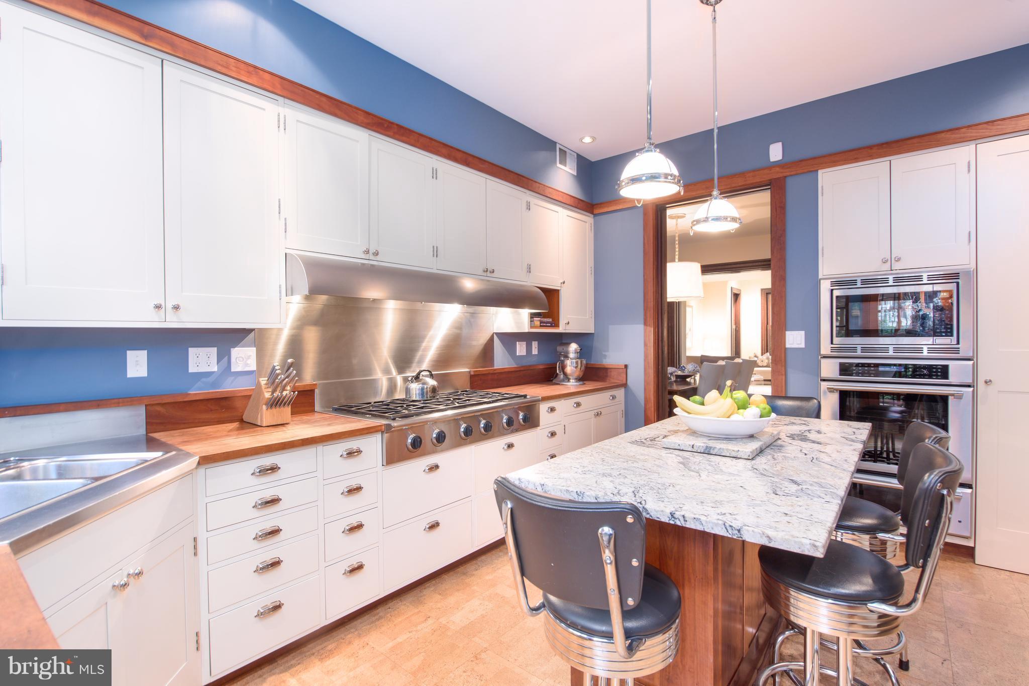 1016 Massachusetts Avenue Northeast Washington, DC 20002 - Photo 9 of 28 a kitchen with stainless steel appliances kitchen island granite countertop a stove a sink and a microwave