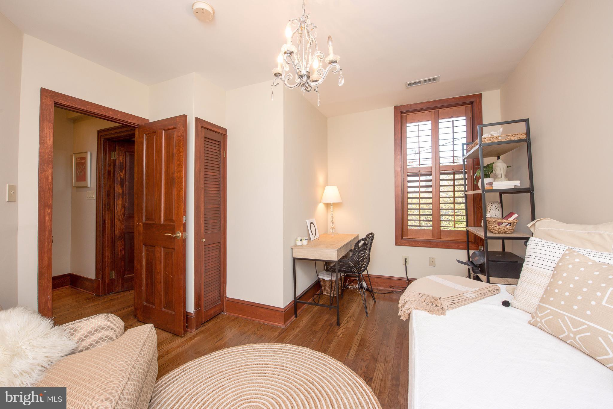 1016 Massachusetts Avenue Northeast Washington, DC 20002 - Photo 10 of 28 a living room with furniture and a chandelier
