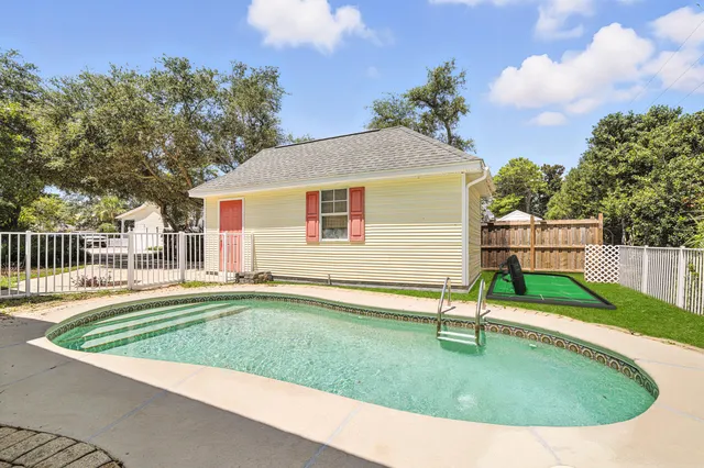 a view of a house with a yard and potted plants