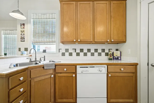 a bedroom with a bed and wooden floors