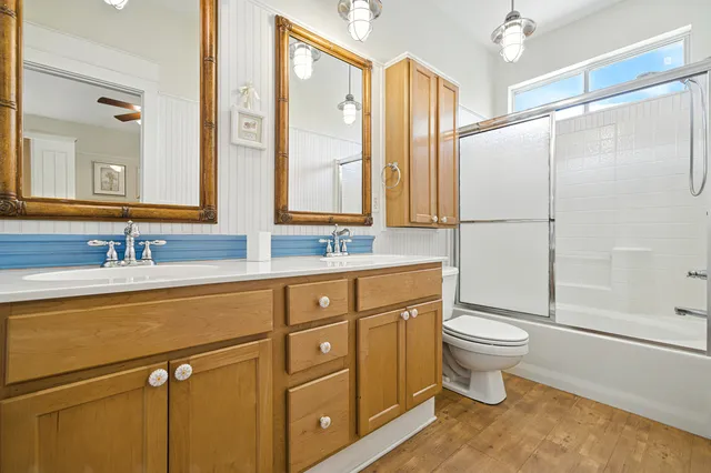 a spacious bedroom with a bed and a chandelier