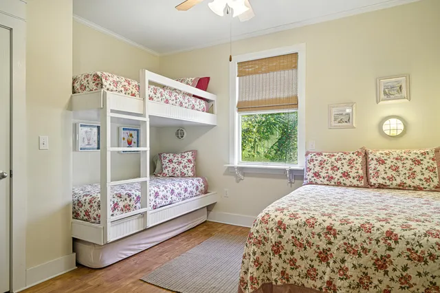 a bedroom with a bed and a flat screen tv on the dresser