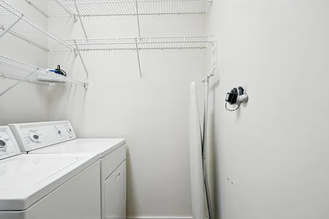 a view of a patio with table and chairs and potted plants