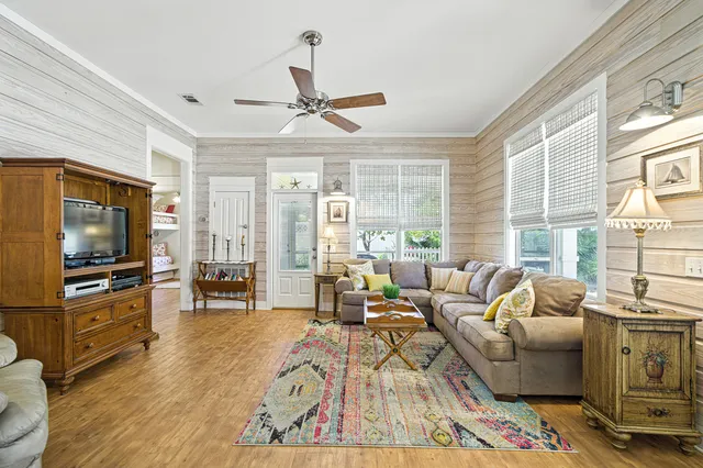 a living room with furniture and wooden floor