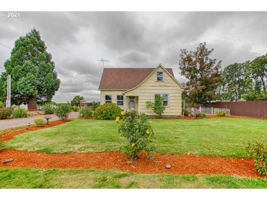 a aerial view of a house with a yard and potted plants