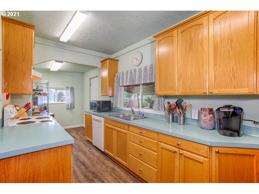 7701 Howell Prairie Road Northeast Silverton, OR 97381 - Photo 12 of 19 a kitchen with lots of counter top space and wooden floor
