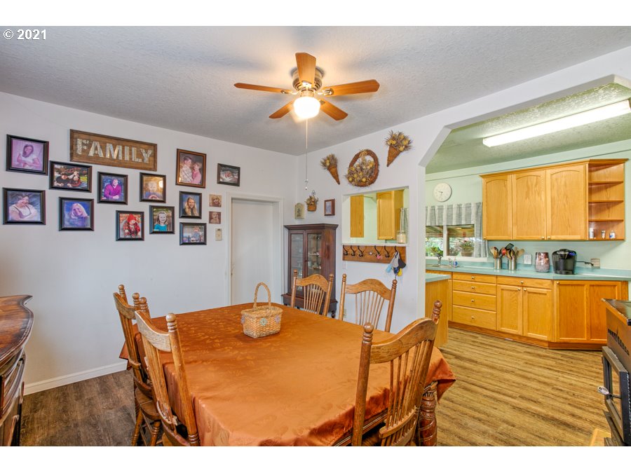 7701 Howell Prairie Road Northeast Silverton, OR 97381 - Photo 14 of 19 a view of a dining room with furniture a kitchen and chandelier