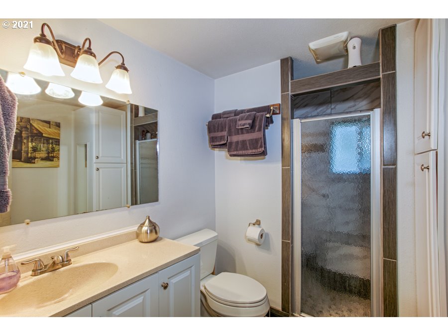 7701 Howell Prairie Road Northeast Silverton, OR 97381 - Photo 15 of 19 a bathroom with a sink a toilet and a mirror