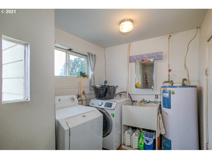 7701 Howell Prairie Road Northeast Silverton, OR 97381 - Photo 17 of 19 a utility room with cabinets washer and dryer
