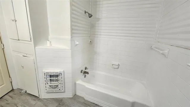 a bathroom with a bathtub and a shower