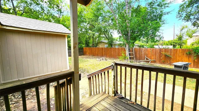 a view of balcony with wooden floor and fence