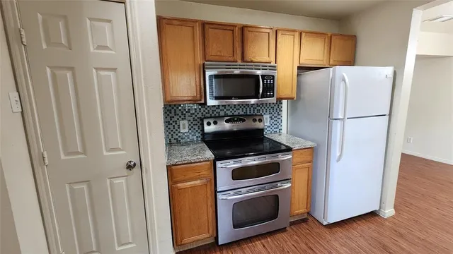 a kitchen with a stove microwave and refrigerator