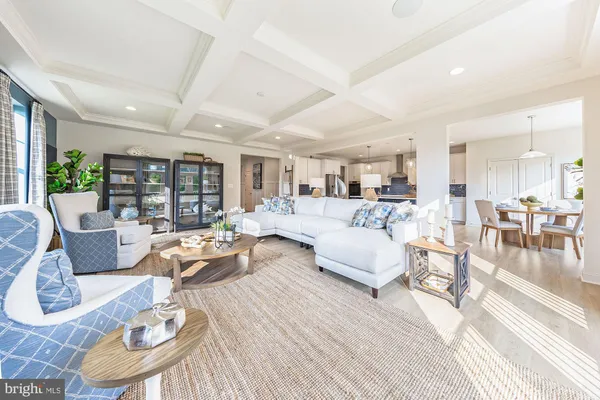 a living room with furniture wooden floor and a table