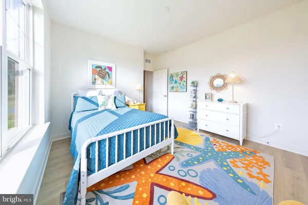 a bedroom with furniture and a wooden floor
