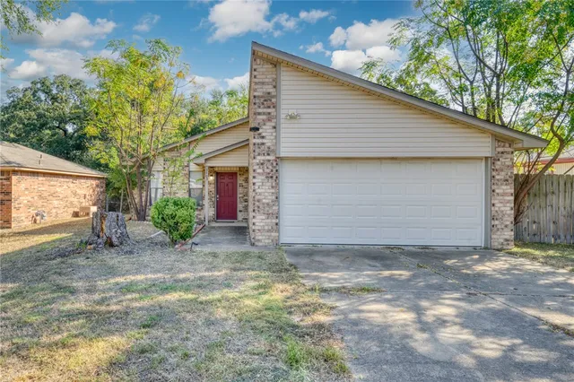 a view of a house with a yard and garage