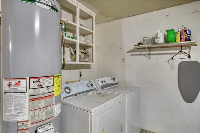 a utility room with a sink dryer and washer