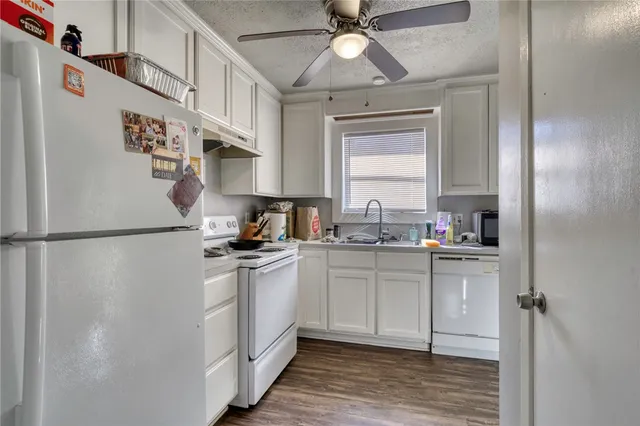 a kitchen with stainless steel appliances a refrigerator sink and cabinets