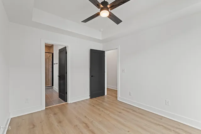 a view of a room with closet and ceiling fan