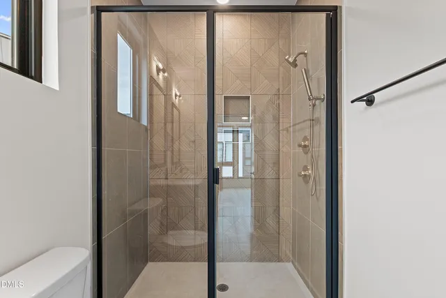 a bathroom with a shower and a mirror