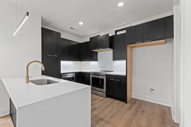 a kitchen with stainless steel appliances granite countertop a refrigerator and a sink