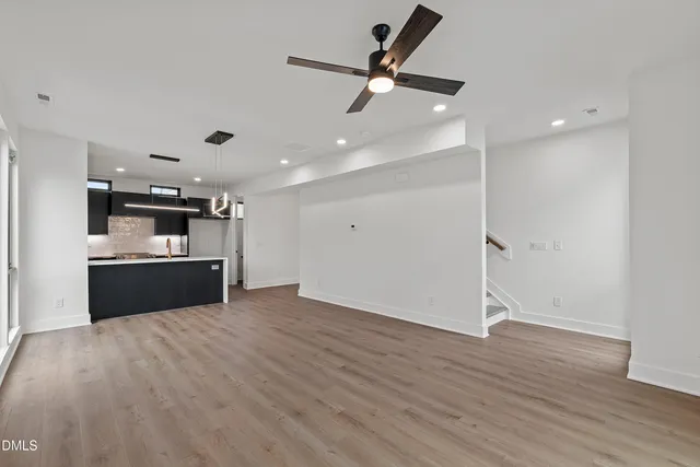 a large kitchen with a sink stainless steel appliances and cabinets