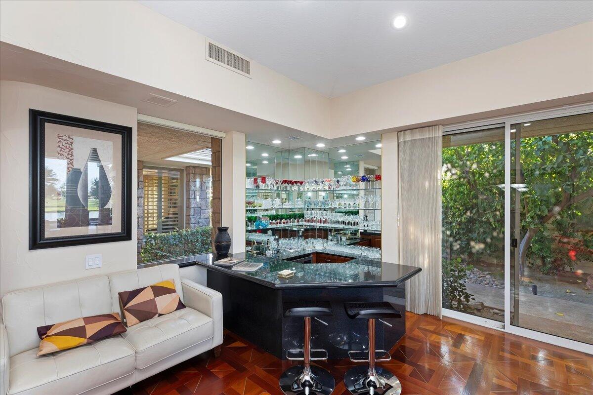 2 Deerfield Court Rancho Mirage, CA 92270 - Photo 26 of 104 a living room with furniture and a floor to ceiling window