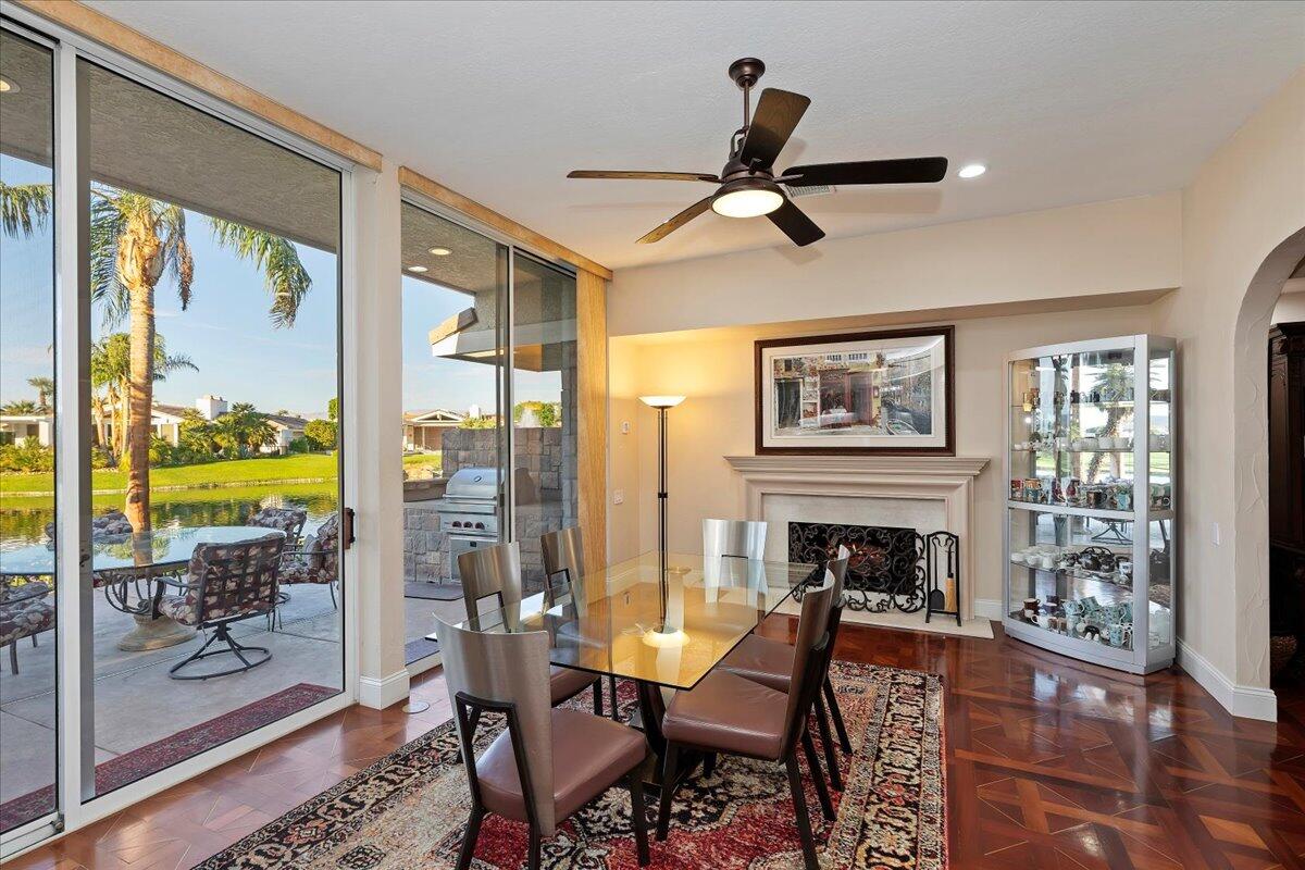 2 Deerfield Court Rancho Mirage, CA 92270 - Photo 41 of 104 a living room with furniture a fireplace and a floor to ceiling window