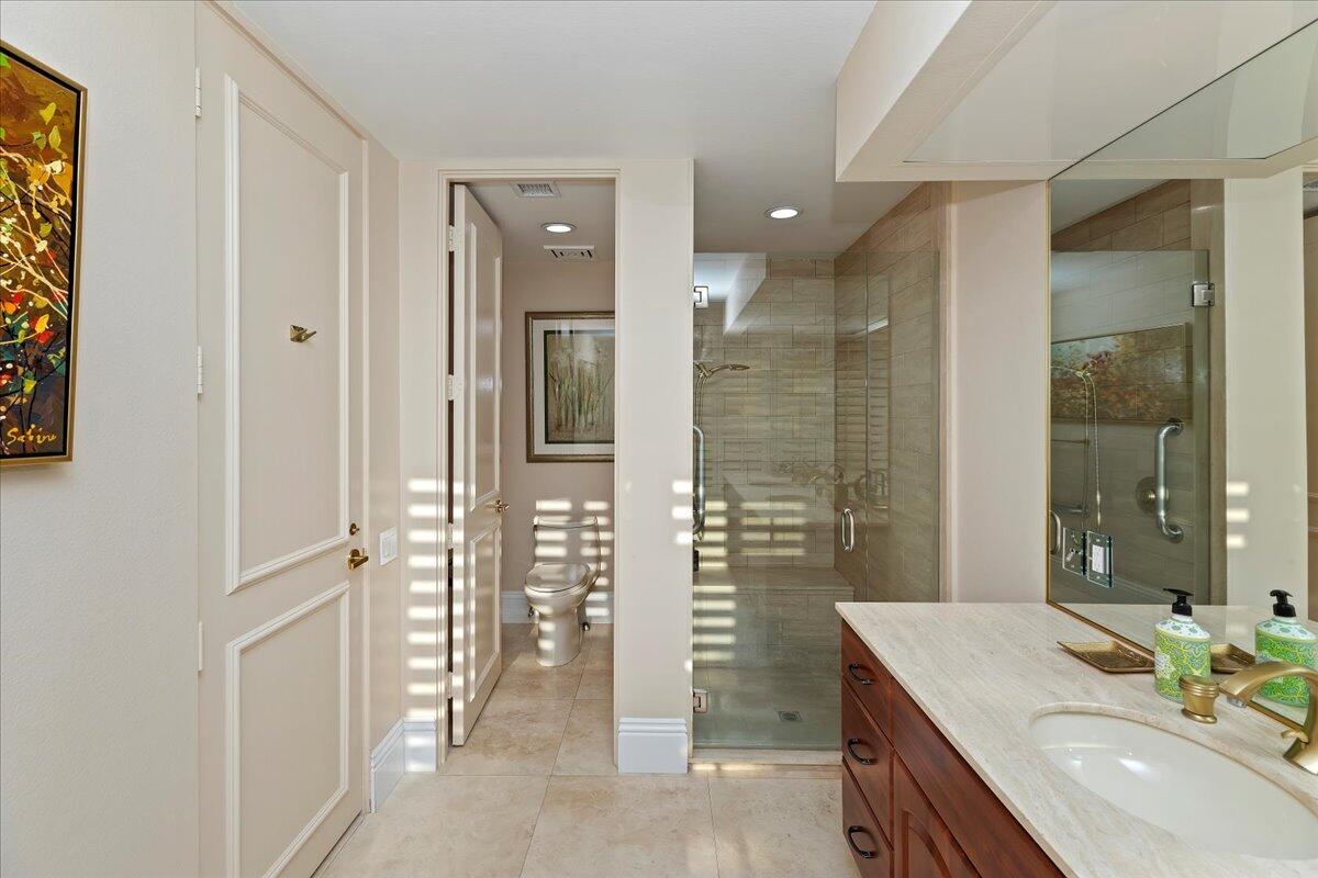 2 Deerfield Court Rancho Mirage, CA 92270 - Photo 51 of 104 a bathroom with a granite countertop sink a shower and a mirror