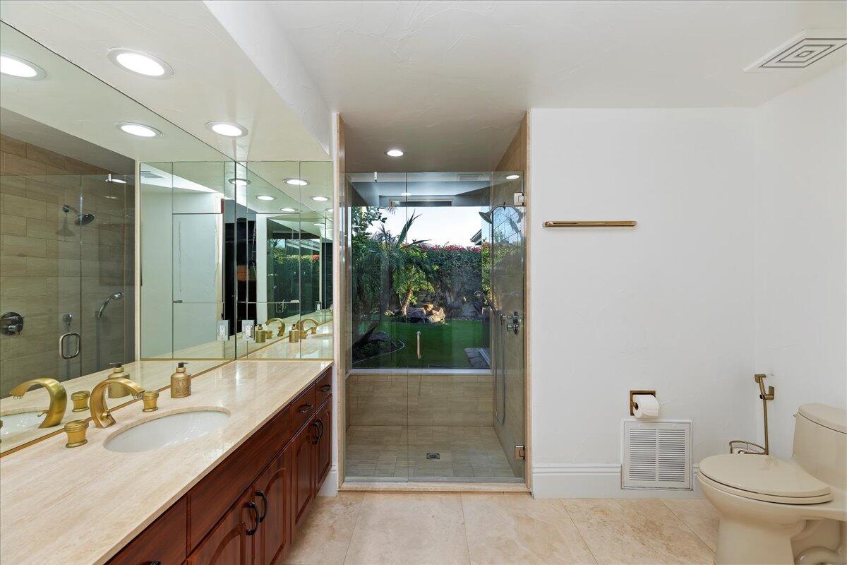 2 Deerfield Court Rancho Mirage, CA 92270 - Photo 60 of 104 a bathroom with a double vanity sink toilet and shower